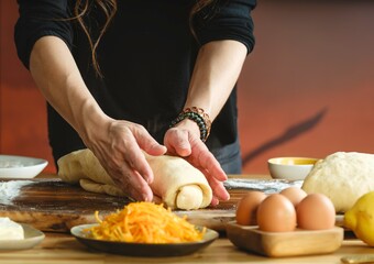A young girl's flour-covered hands knead dough on a wooden table, surrounded by ingredients. This...
