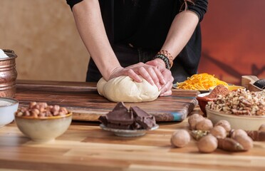 In a warm kitchen, a young girl’s hands knead dough, capturing the joy of baking and the tactile experience of culinary heritage, fostering learning and family connections through homemade treats