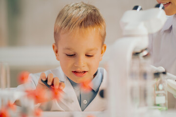 The boy looks enthusiastic, learning in the laboratory. Real People The Boy Education Laboratory.