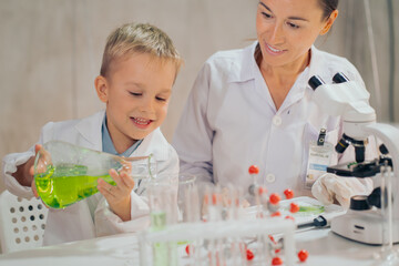 The boy looks enthusiastic, learning in the laboratory. Real People The Boy Education Laboratory.