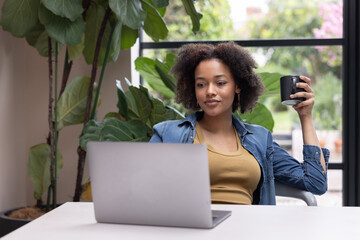 Young Woman Engaged in Online Work working from home with Coffee