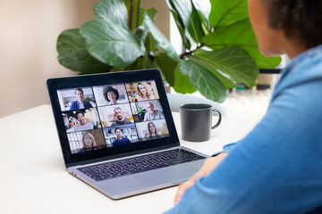Woman working from home in a virtual meeting with diverse participants