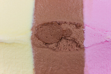 A view reveals three distinct vertical layers of Neapolitan ice cream. Vanilla, chocolate,...