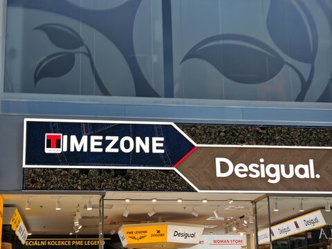 Prague,Czech Republic-April 8 2025: Desigual and Timezone brands displayed on storefront of fashion retailer, known for bold clothing styles.

