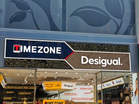 Prague,Czech Republic-April 8 2025: Desigual and Timezone brands displayed on storefront of fashion retailer, known for bold clothing styles.

