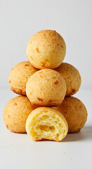 Fototapeta premium Traditional cheese bread, golden crust, soft interior, stacked on plain white background, studio lighting
