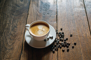 Coffee cup and coffee beans on wooden table, Espresso Crema coffee cup aromatic