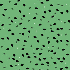 Seamless pattern with watermelon seeds on a green background. Perfect for summer designs, packaging and textiles.