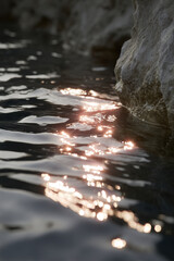 serene landscape featuring soft waves gently lapping against rocky shore creating mesmerizing reflections on waters