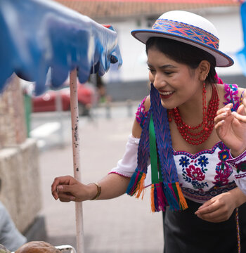 Indigenous riobamba woman selling food on street market in ecuador