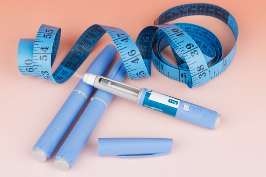 Horizontal layout of semaglutide pens and blue tape for weight and glucose control