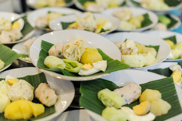 Siomay with hard boiled egg, potato and cabbage on a white plate