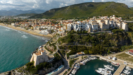 Obraz premium Aerial view of the town of Sperlonga, in the province of Latina, Lazio, Italy. The village is built on a promontory overlooking the Mediterranean Sea. In the foreground is the tower, symbol of the tow