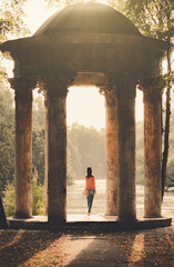 A Woman Stands Alone In A Rotunda In A Park On A Sunny Cozy Romantic Atmosphere
