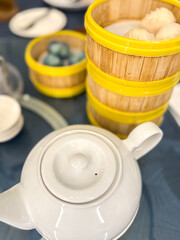 Close-up of a Chinese dim sum setting with bamboo steamers filled with har gow (hakau) and crystal...