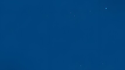 Uniform deep blue background with subtle specks.