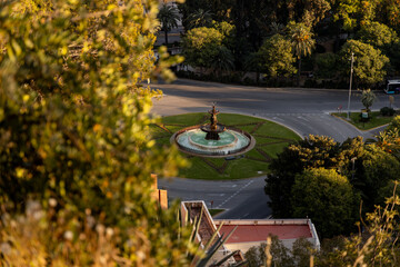 Malaga, View from Alcazaba, Spain. Scenic view of a circular fountain surrounded by lush greenery...