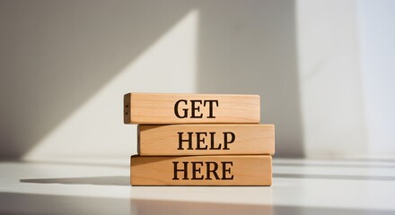 Wooden blocks spelling out 'Get Help Here', symbolizing support and assistance available

