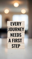 Wooden blocks spelling out 'Every Journey Needs a First Step', symbolizing beginnings and motivation

