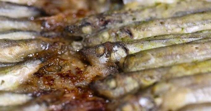 capelin fish fried in plenty of oil, stacked in rows cooked hot capelin baked in sunflower oil in the oven