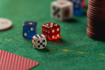 Colorful Dice on a Green Felt Table Surrounded by Poker Chips and Cards at a Casino Game Night Gathering