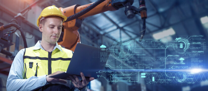 professional engineer, advance technology in modern factory industry control operate robot welding arm machine with laptop program software