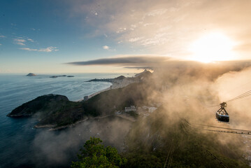 Famous View of Rio de Janeiro Coast from the Sugarloaf Mountain Under Clouds on Sunset and Cable Car Approaching