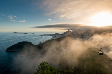 Famous View of Rio de Janeiro Coast from the Sugarloaf Mountain Under Clouds on Sunset and Cable Car Approaching