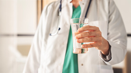 Female doctor holding a glass of water