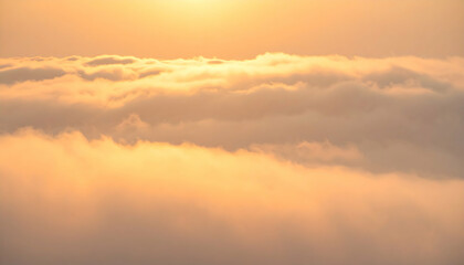 Fototapeta premium Golden Hour Cloudscape: Aerial View of Soft Orange and Yellow Clouds at Sunset