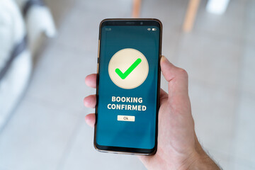 Booking confirmed notification on smart phone. Concept of booking a vacation stay