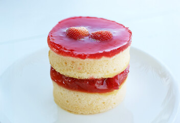 Closeup of delectable strawberry chiffon cake on a white plate