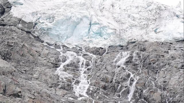 The melting of Alpine glaciers, waterfalls under seracs, Italy