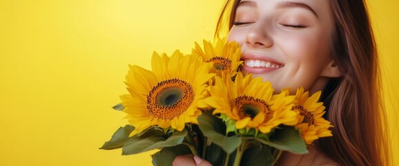Naklejka premium A joyful young woman embraces a vibrant bouquet of sunflowers, her smile radiating happiness on a bright yellow backdrop