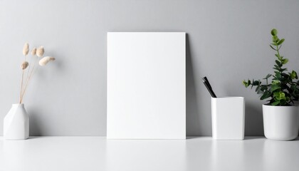 Minimalist studio setup with blank canvas, botanical accents and writing tool