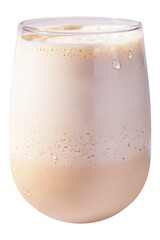 A clear glass filled with a creamy iced latte topped with a thin milk foam and subtle layering. Condensation droplets appear on the outer surface of the glass.