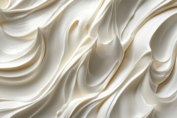Obraz premium Close-up shows swirls of shiny, smooth, pale cream, creating a fluid texture. Perfect for baking designs or cosmetic product presentation background.