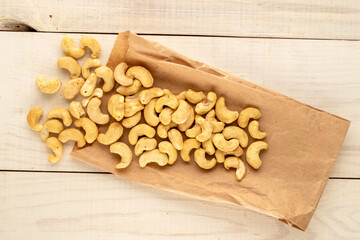 Organic cereals with paper bag on wooden table, close-up, top view.
