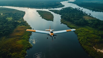 Aerial photography of a propeller plane gliding over a river