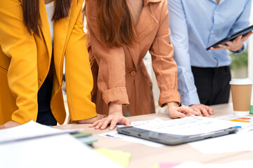 Asian business strategist managers, and finance professionals gather in a corporate office for an internal meeting, sharing esg ideas, presenting documents, teaching, and analyzing financial graphs 
