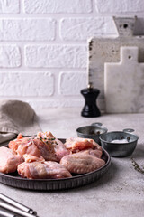 Raw chicken wings on black background.