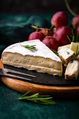 Different types of cheese, wine and grapes