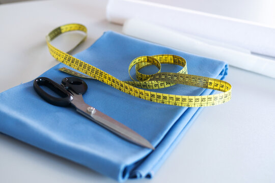 Sewing Tools with Blue Fabric, Scissors and Measuring Tape