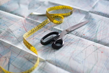 Sewing tools on pattern paper with measuring tape