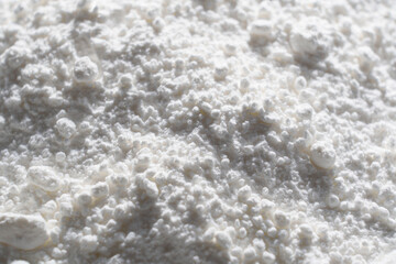 Close-up of tapioca starch or flour powder in spoon with white background