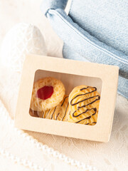 close up of set of cute cookie shaped hairpins against the background of a blue bag, pearls and headphones