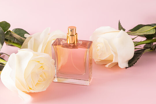 Elegant perfume bottle with white roses