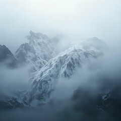 Obraz premium The image captures a dramatic mountain landscape shrouded in mist and fog, evoking a sense of mystery and grandeur.