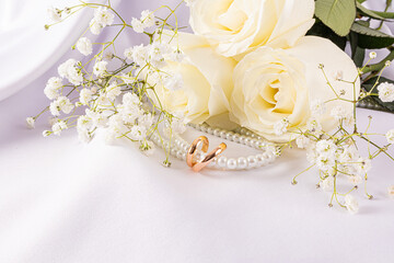 Elegant wedding rings with white roses and pearls