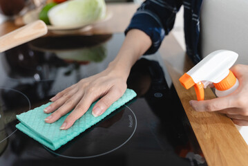 person cleaning food stain in the kitchen